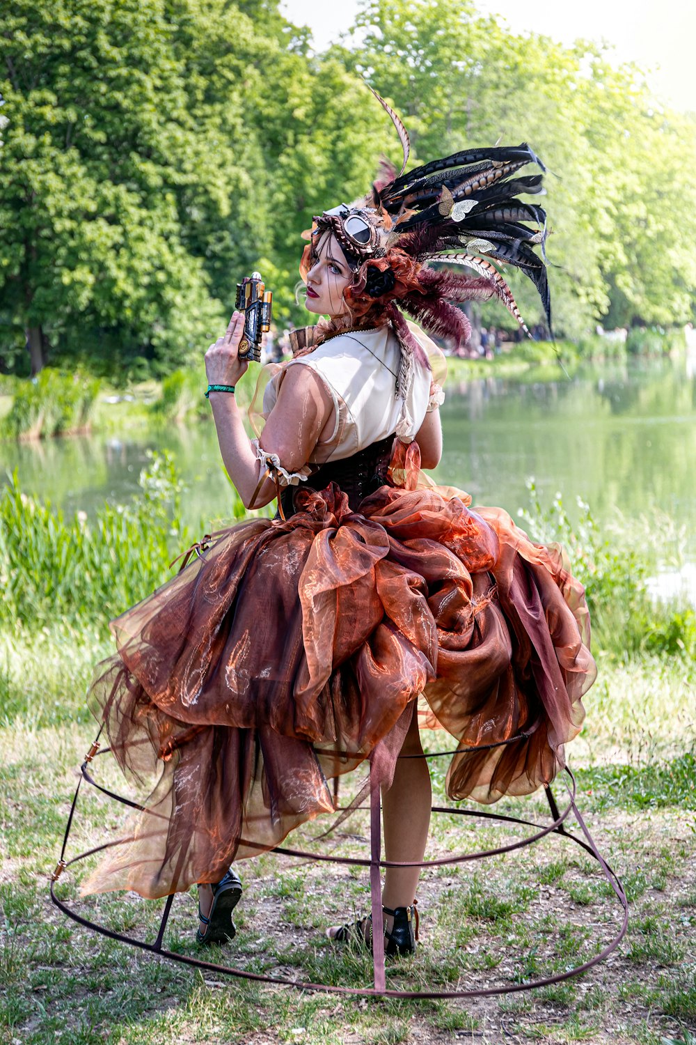 a person sitting on a chair with a large feathered headdress