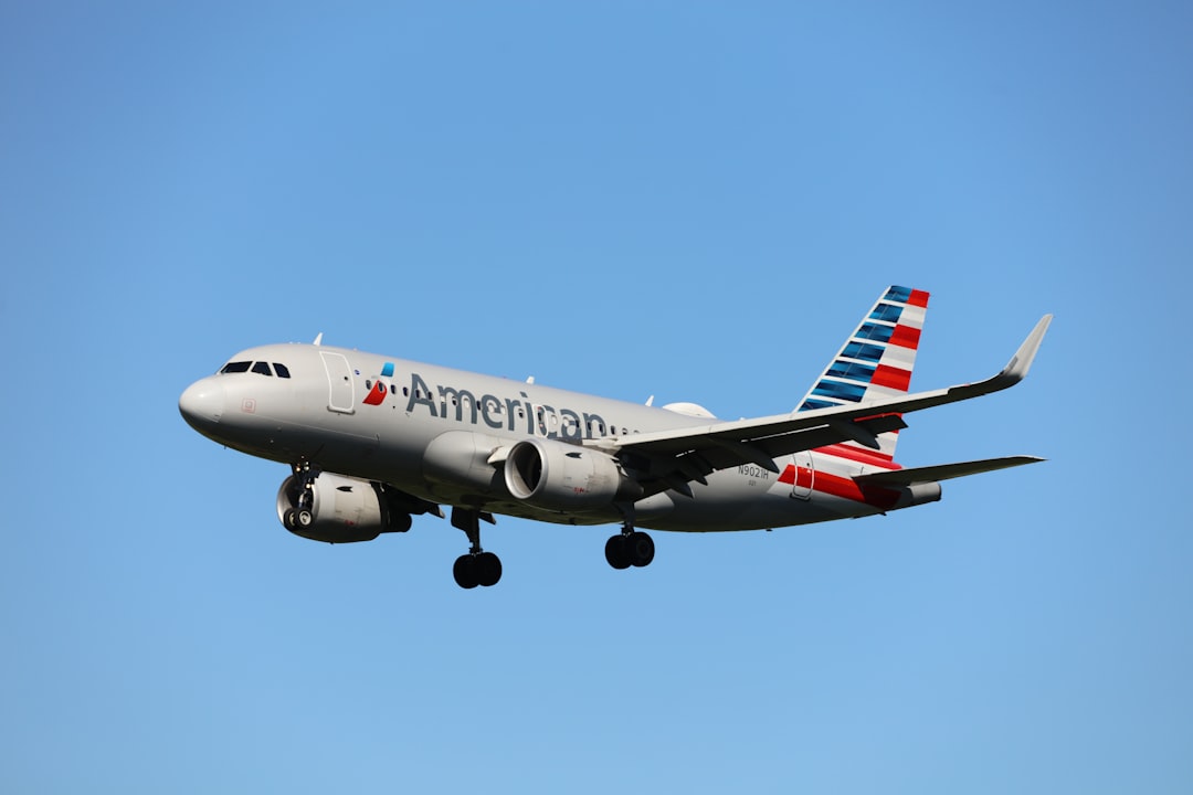 a large airplane flying in the sky, American Airlines Airbus A319-115