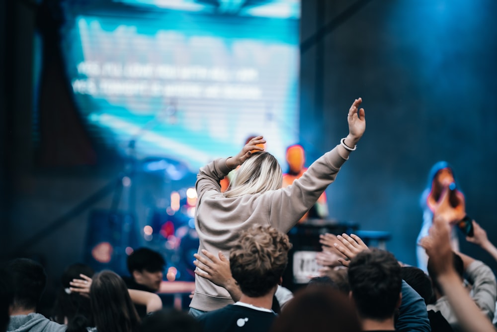 a person standing on a stage in front of a crowd