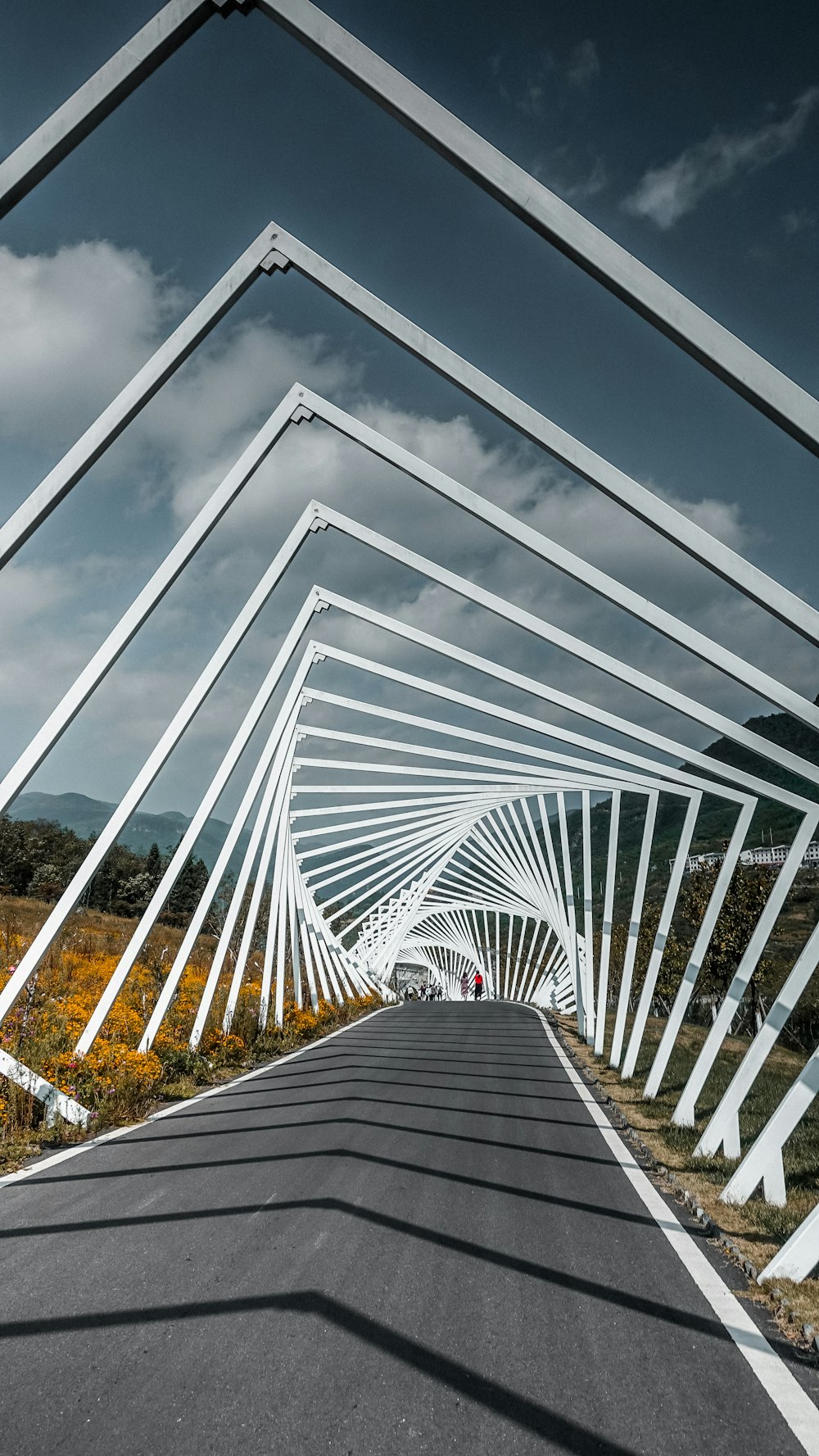 a white bridge with a walkway with Eli and Edythe Broad Art Museum in the background