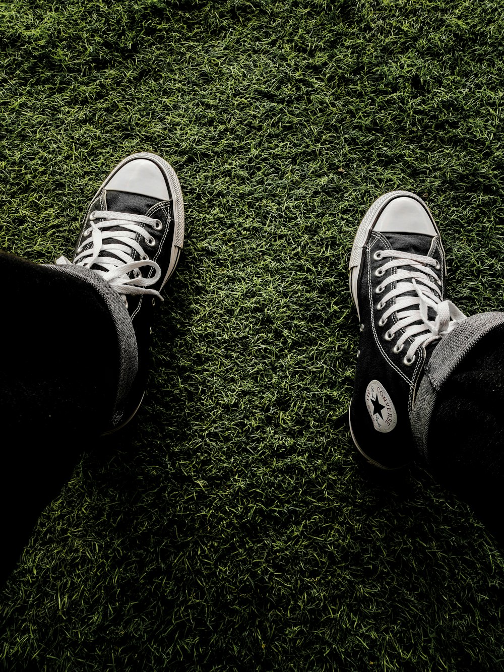 a pair of black shoes on grass