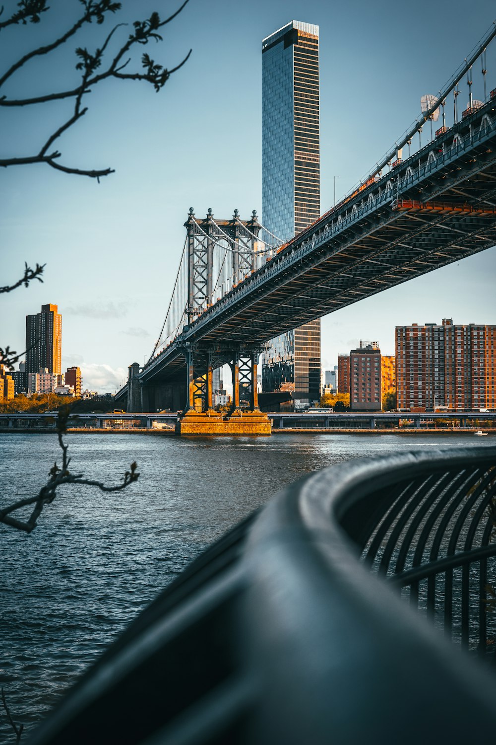 a bridge over water with a city in the background