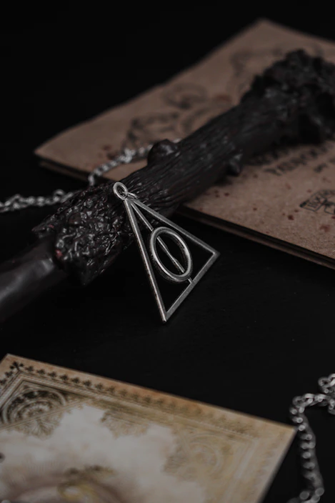 Close-up of a delicate handmade pendant resting on aged parchment with ancient symbols.
