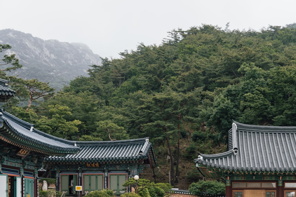 a group of buildings with trees in the back