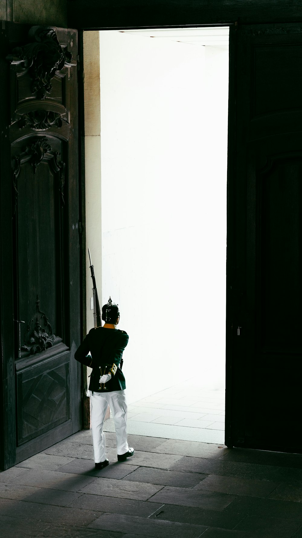a man in a uniform standing in a doorway