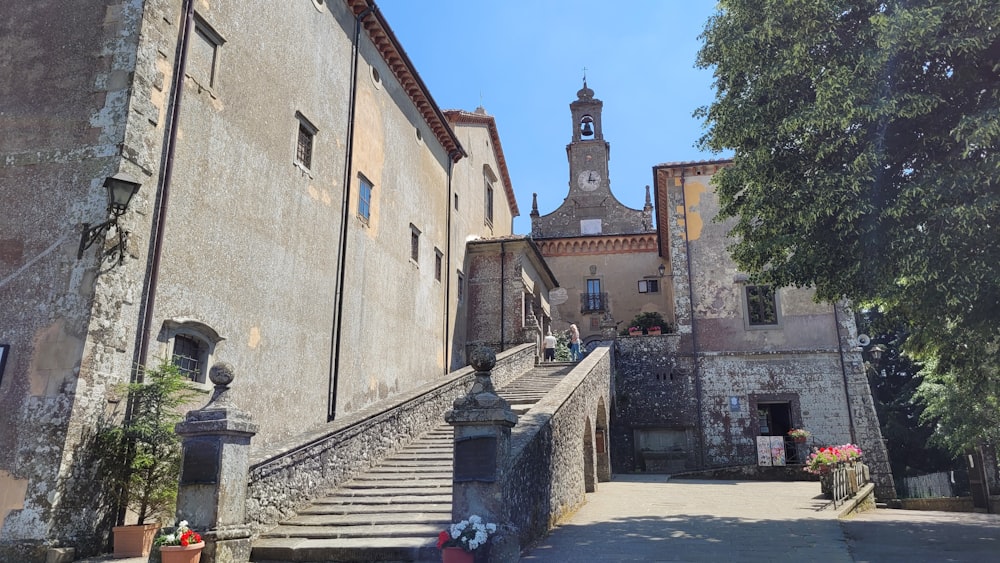 a stone building with stairs and a steeple