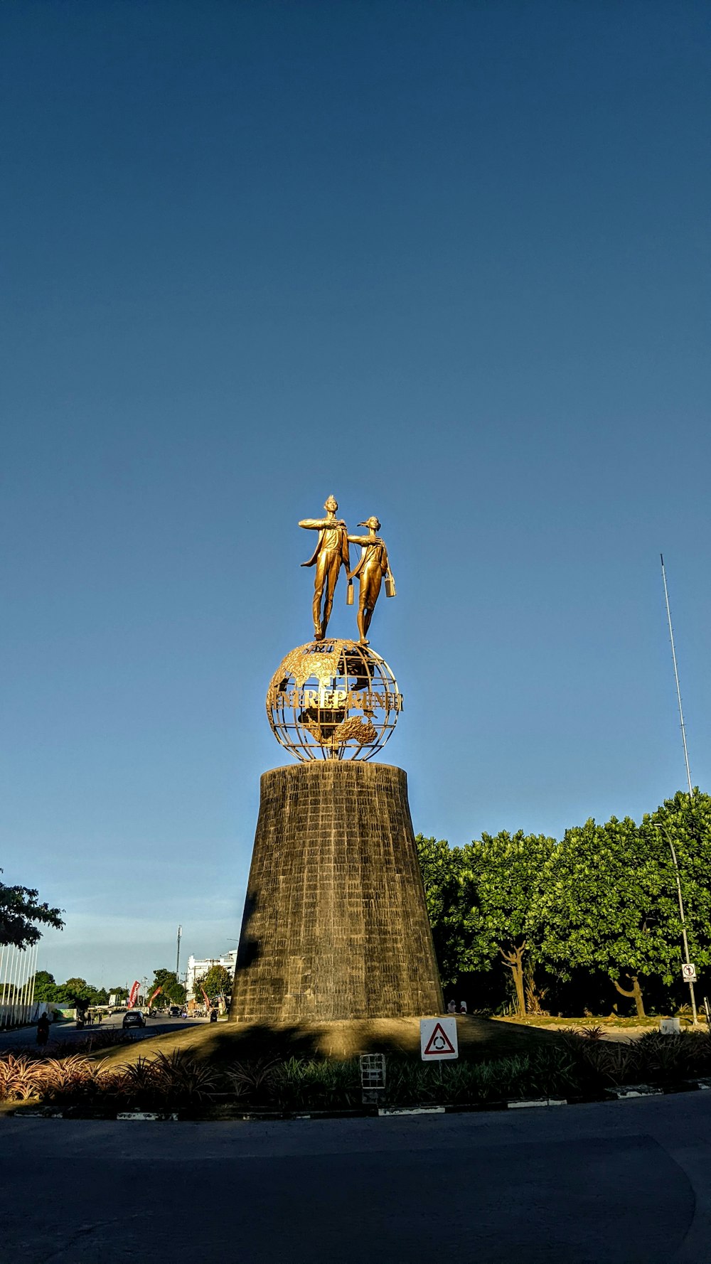 a gold statue on top of a gold dome