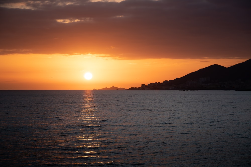 a body of water with a sunset