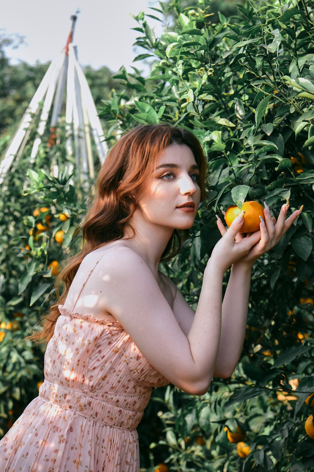 a woman holding an orange