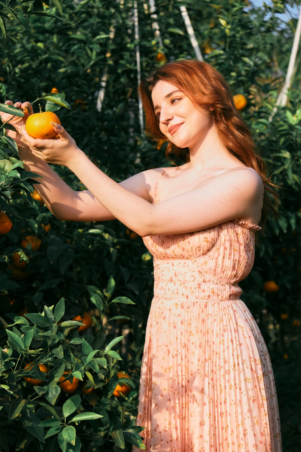 a person holding an orange