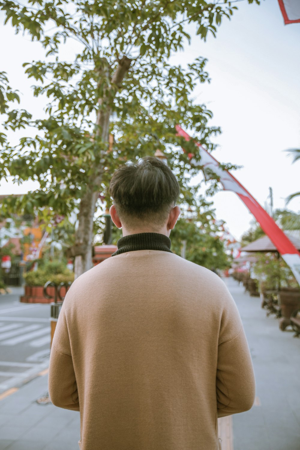 a man with a tree in the background