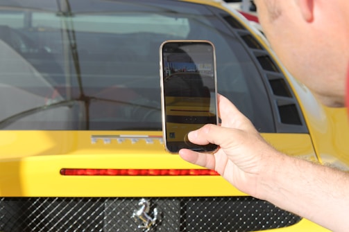 Close-up of a smartphone showing a quick car valuation form on the Carsuvan website.