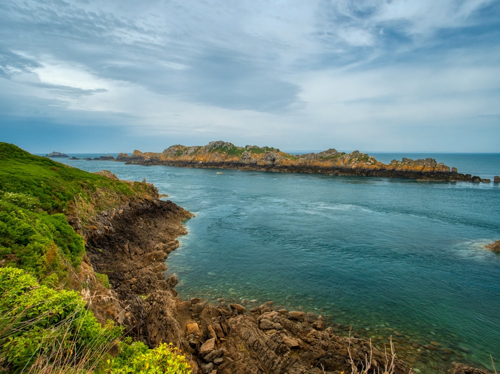 a body of water with land in the back