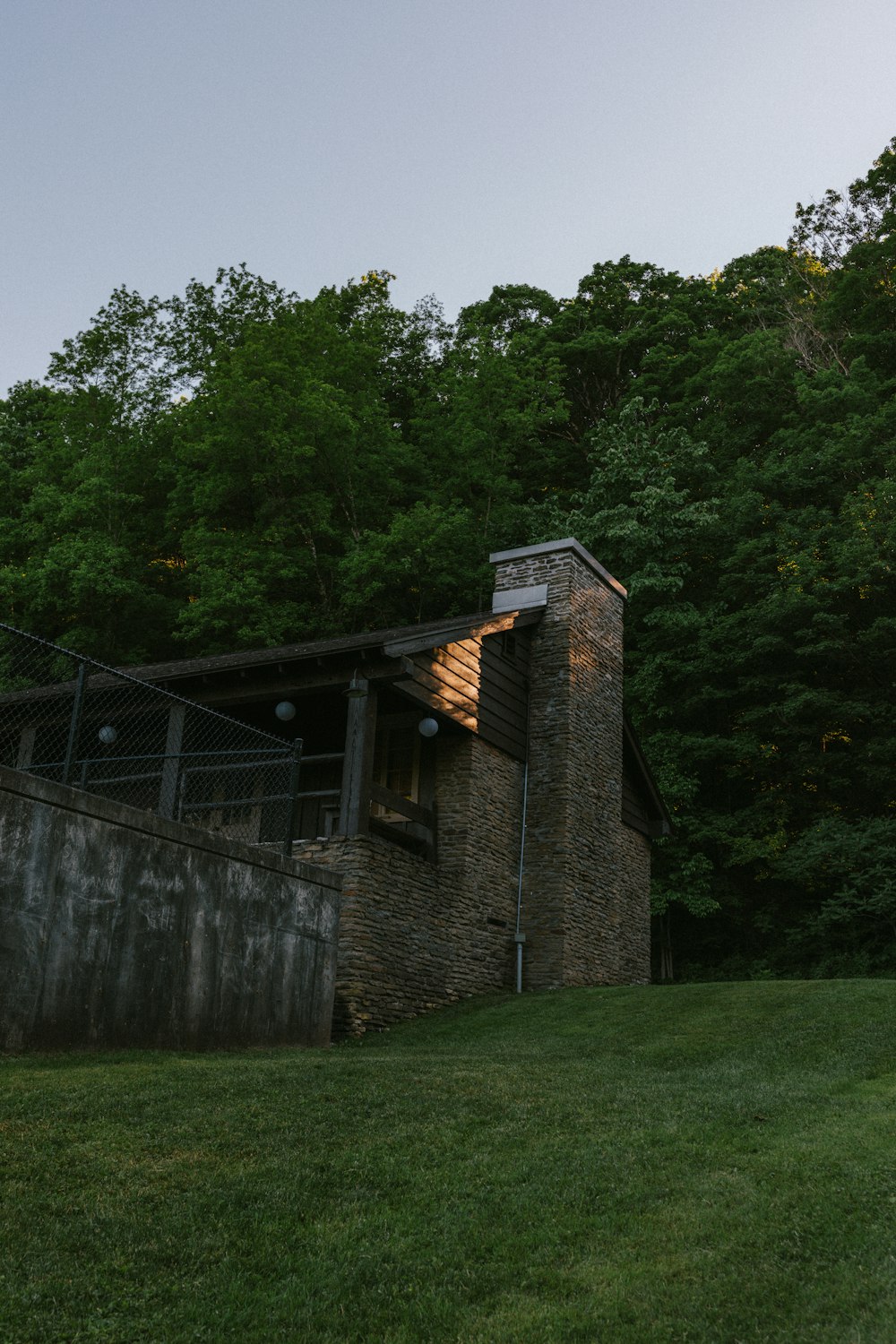 a brick building with a fence around it