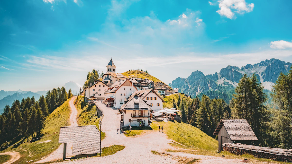 A small quiet Italian village perched on a hillside with mountains in the background