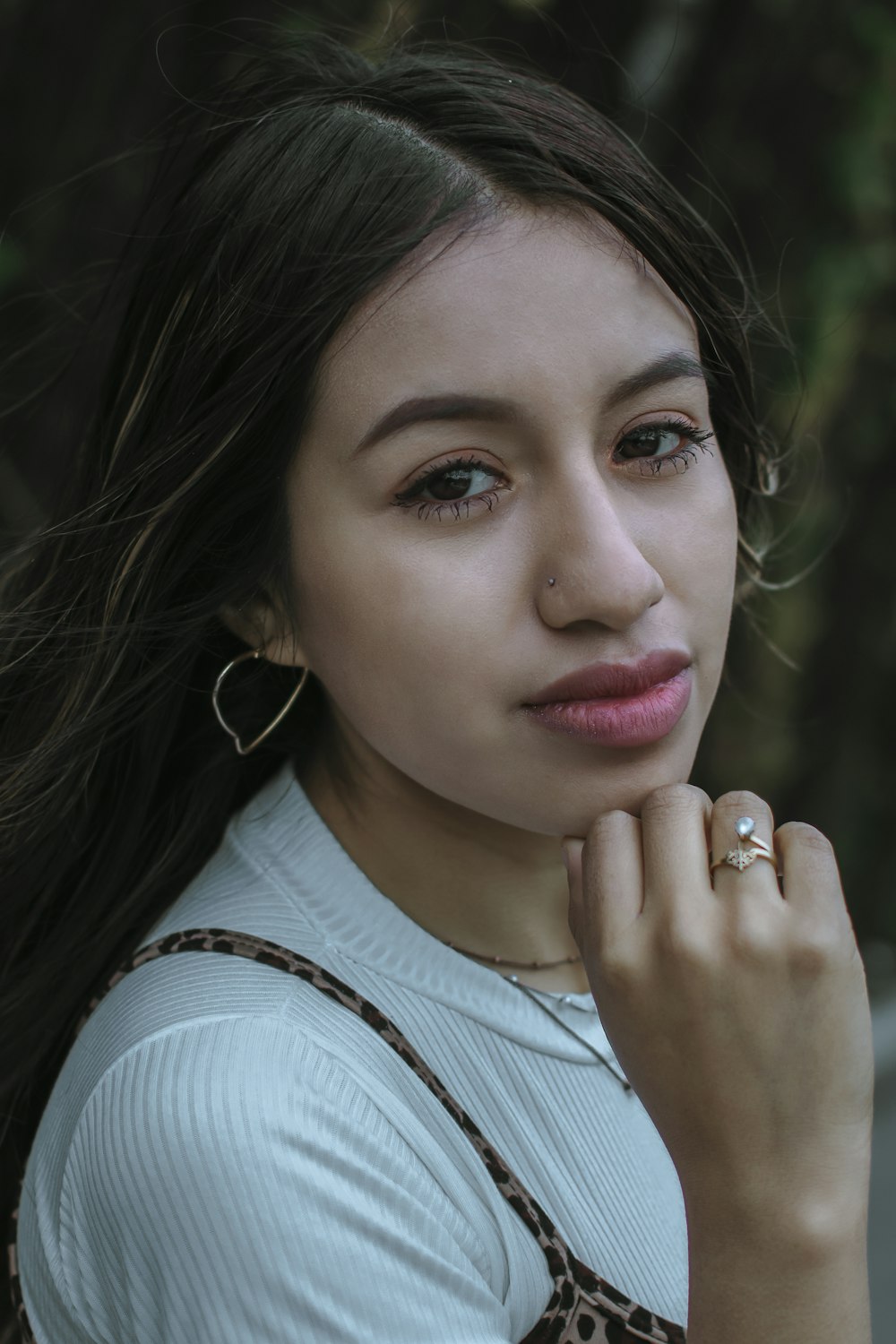 a woman with her hand on her chin