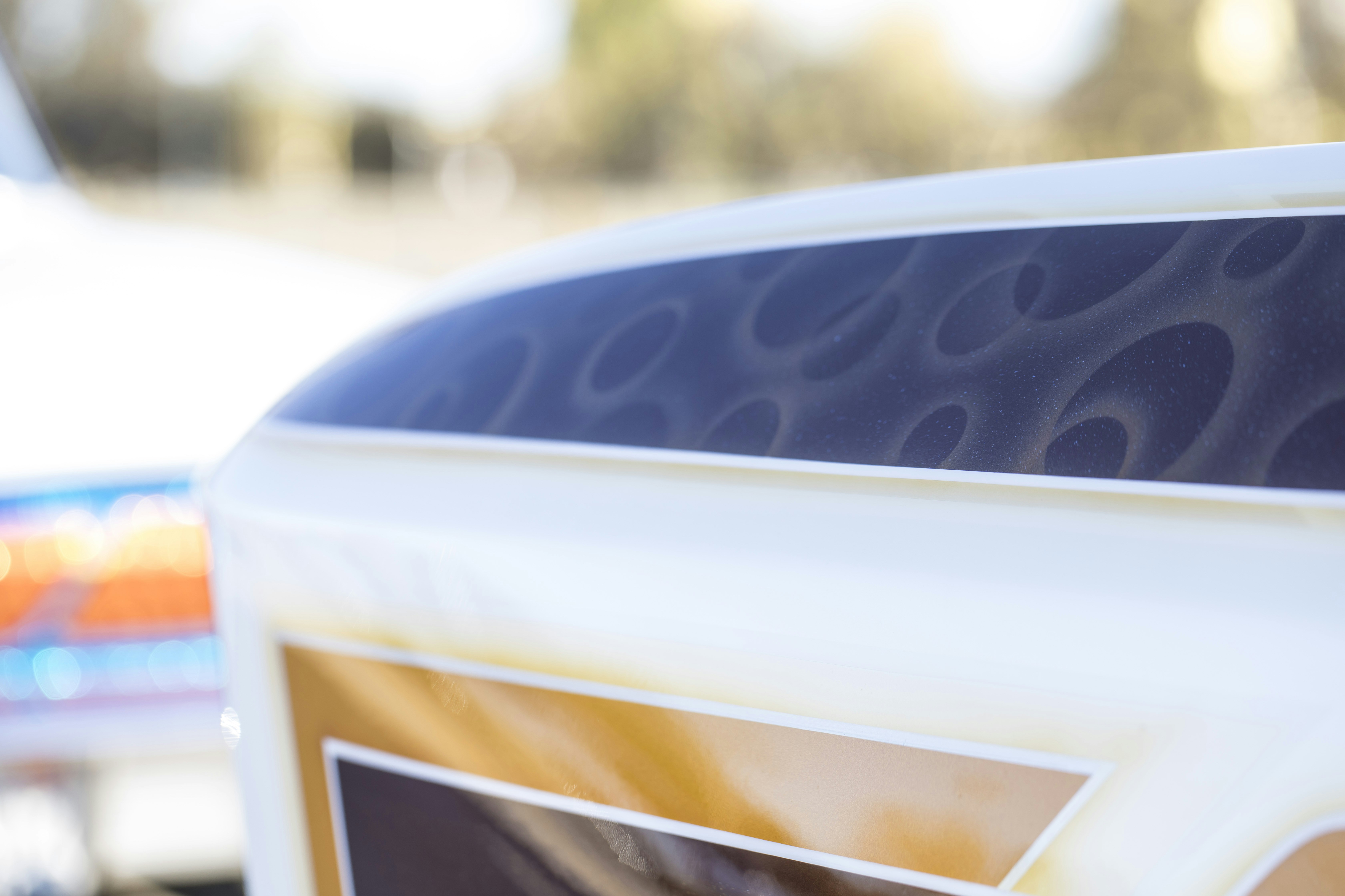 Intricate custom airbrush designs on a painted vehicle surface.
