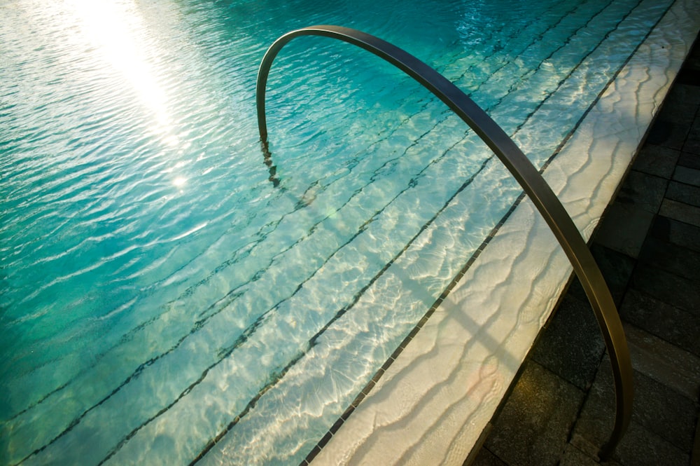 a metal railing over a pool