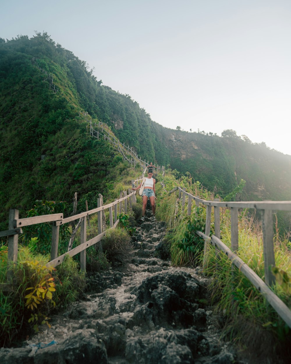 a person walking on a wooden bridge