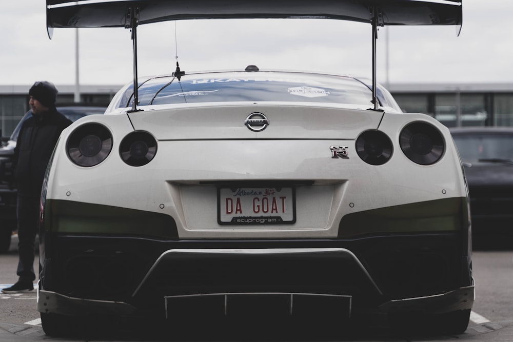 a white car with a person standing next to it