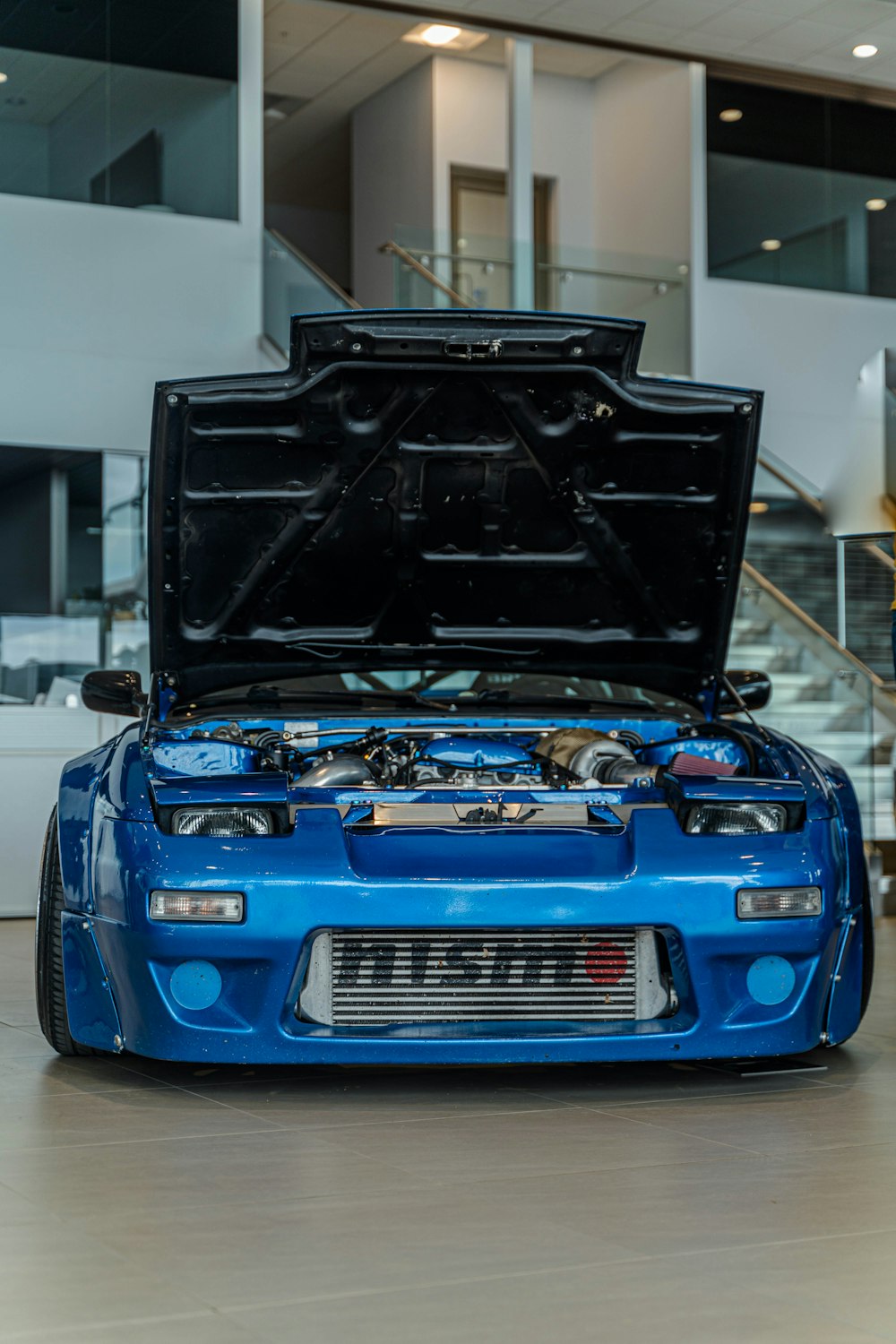 a blue car with its hood open