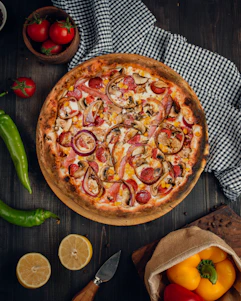 a pizza with tomatoes and onions
