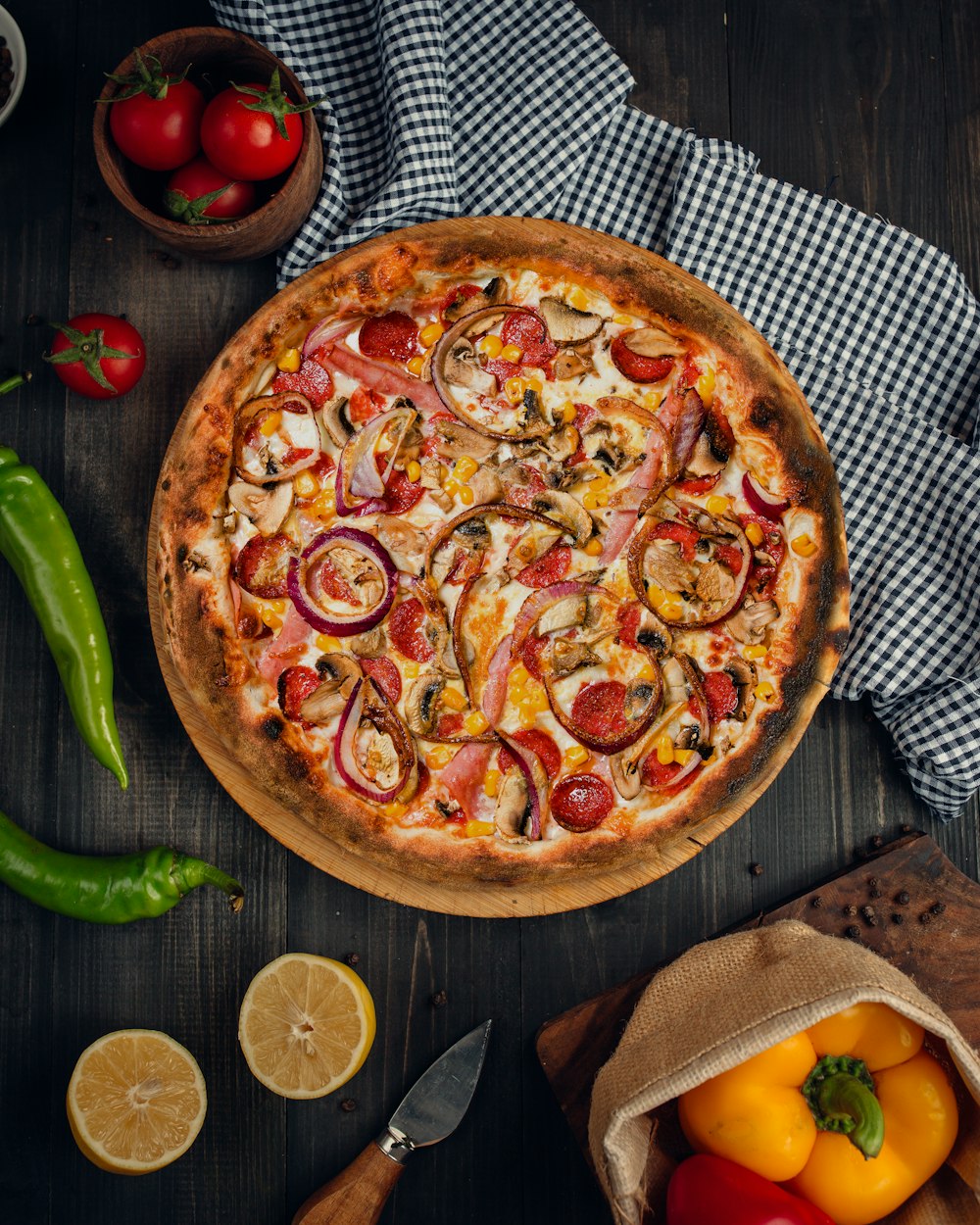 a pizza with tomatoes and onions