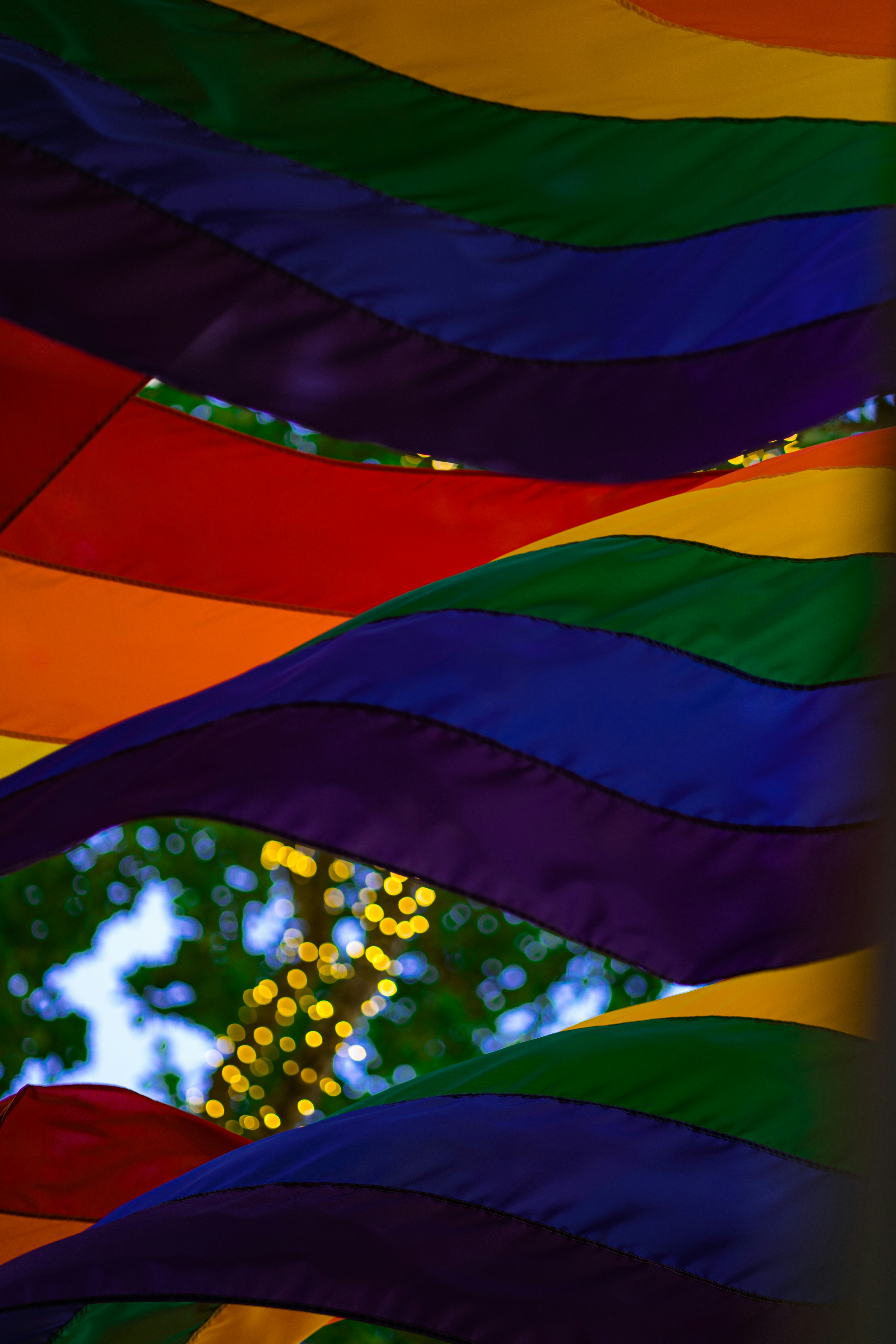 A rainbow flag hanging from the side of a house photo – Free Car Image on  Unsplash, image size:3000x4500