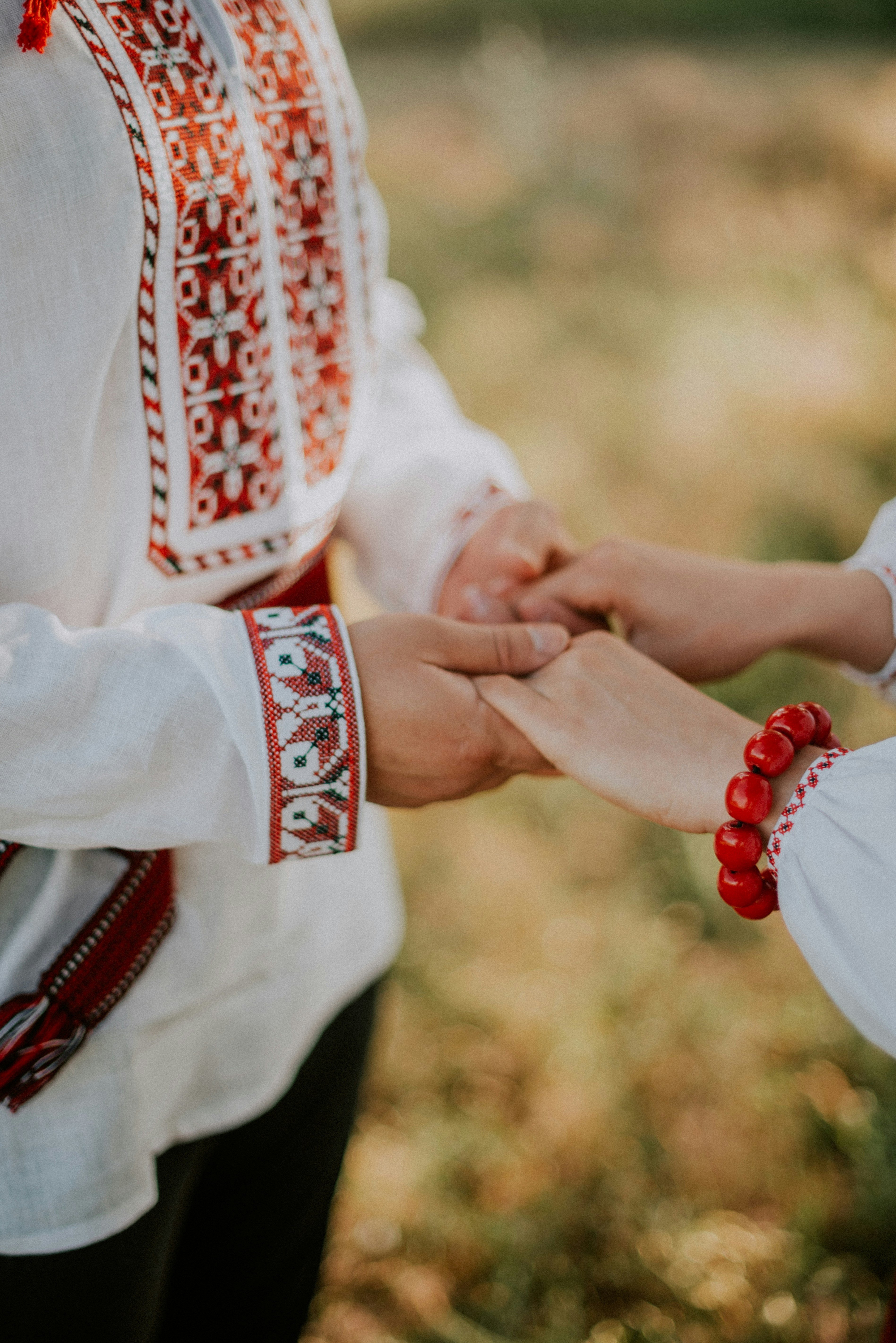 a close-up of hands holding a baby