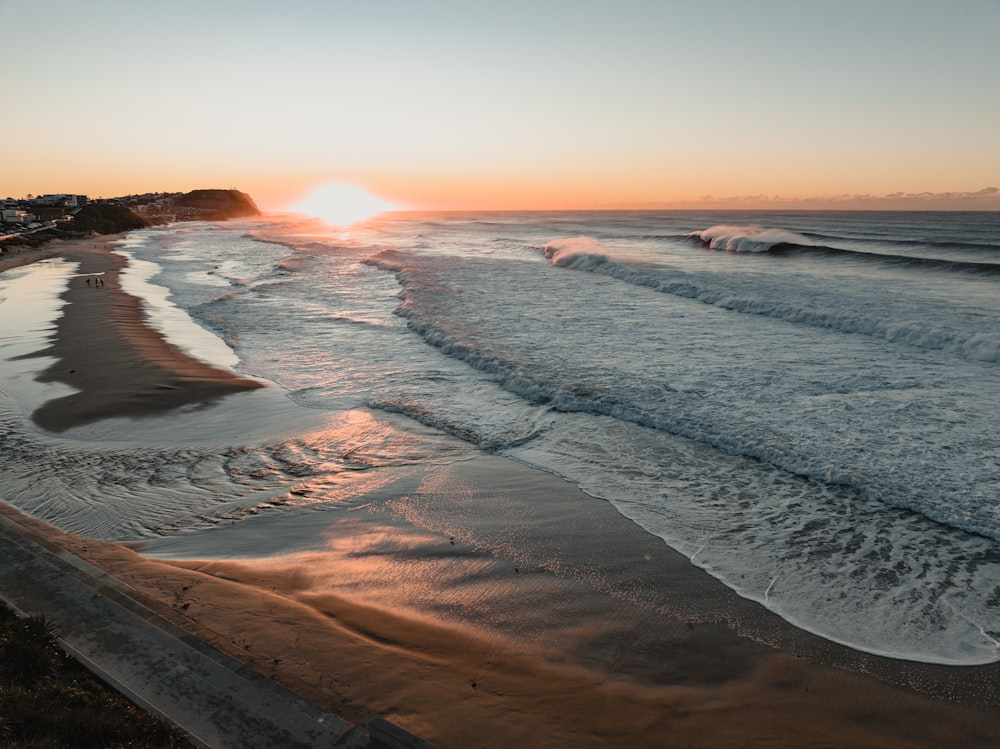 a beach with waves crashing on it