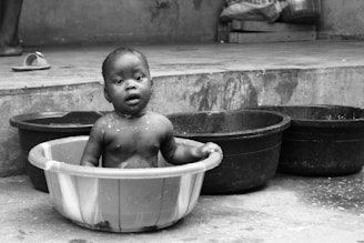 a baby in a bucket