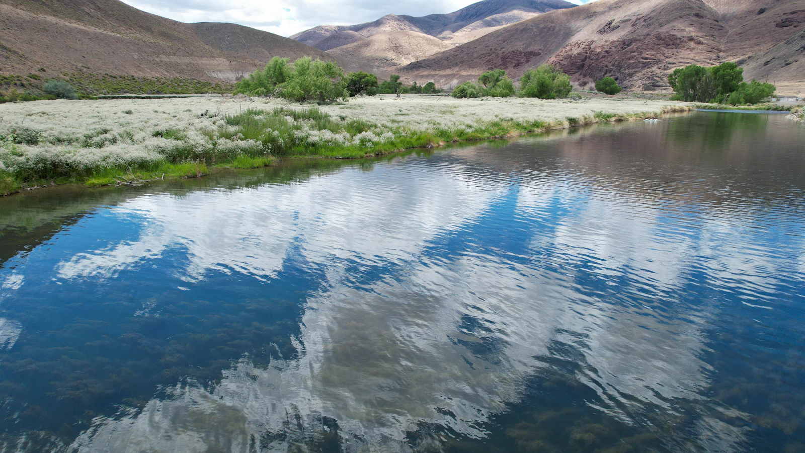Open water with dry hills behind it.