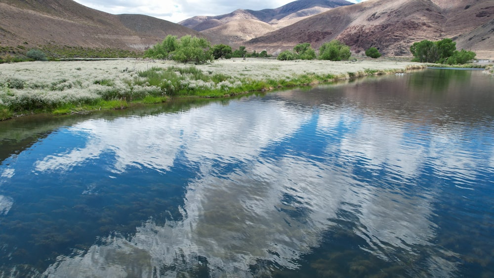 a body of water with hills in the background