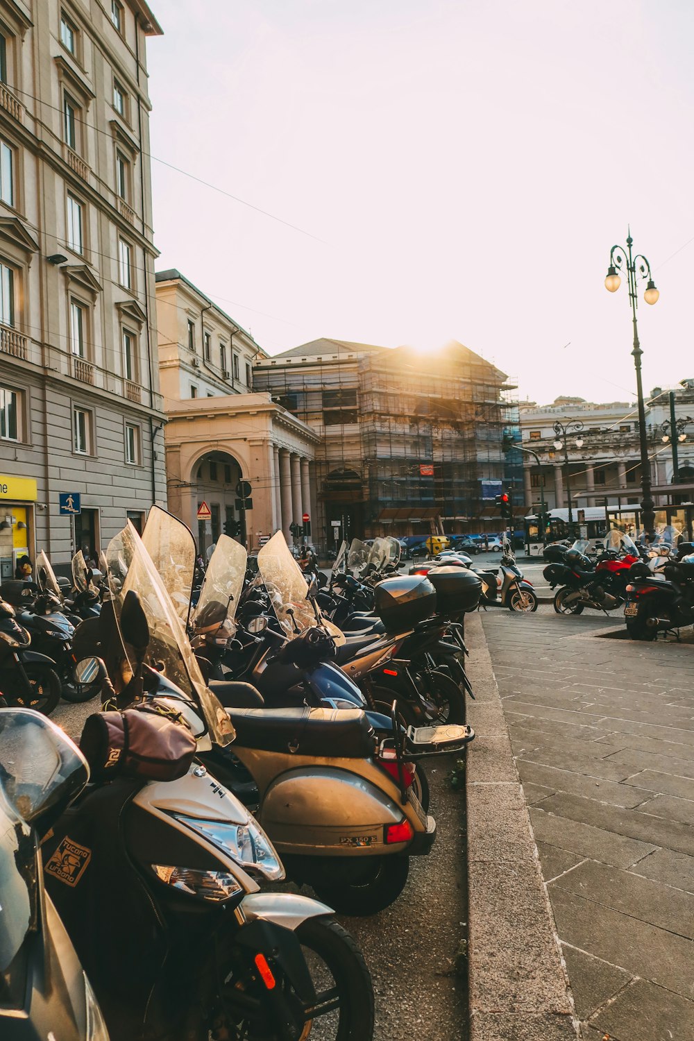 a group of motorcycles parked on the side of a street