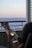 A couple relaxing on the balcony with ocean views.
