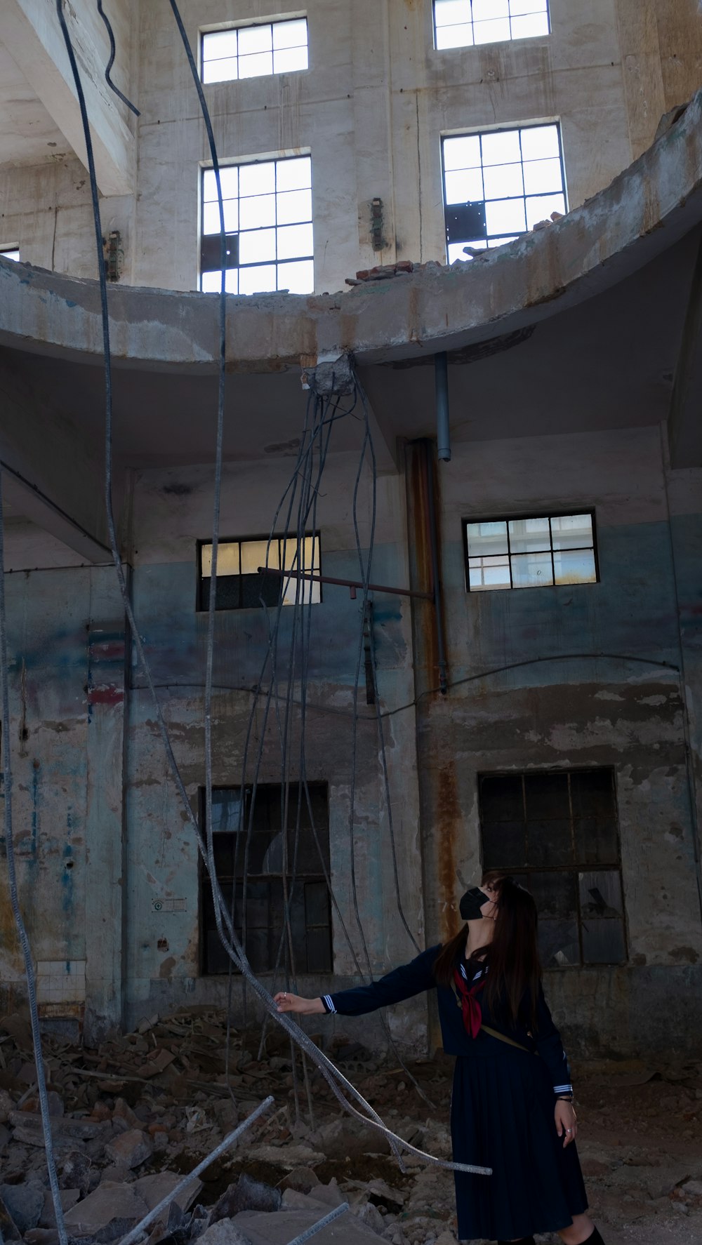 a person standing in front of a building with a staircase