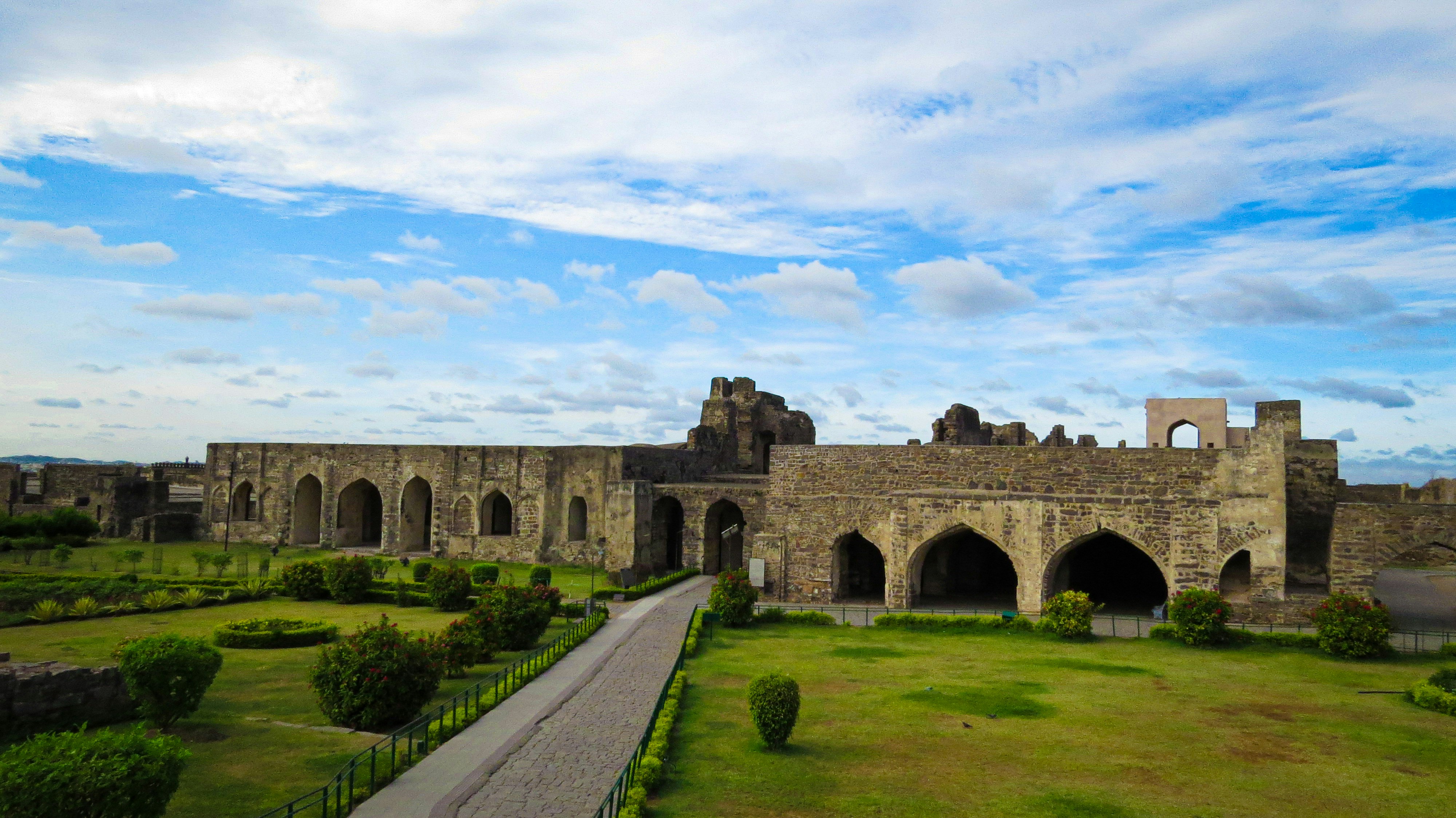 a large stone building with a walkway