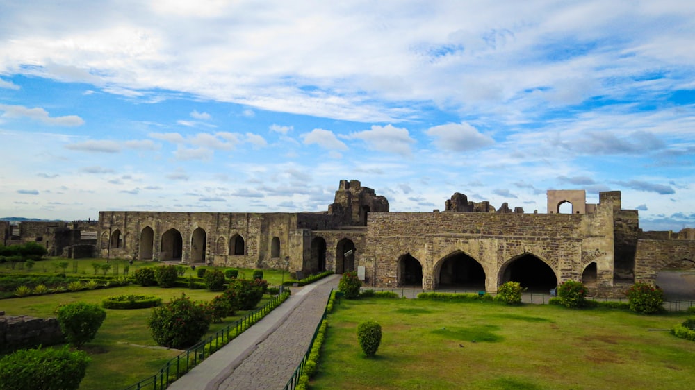 a large stone building with a walkway