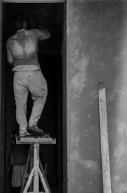 a man standing on a ladder