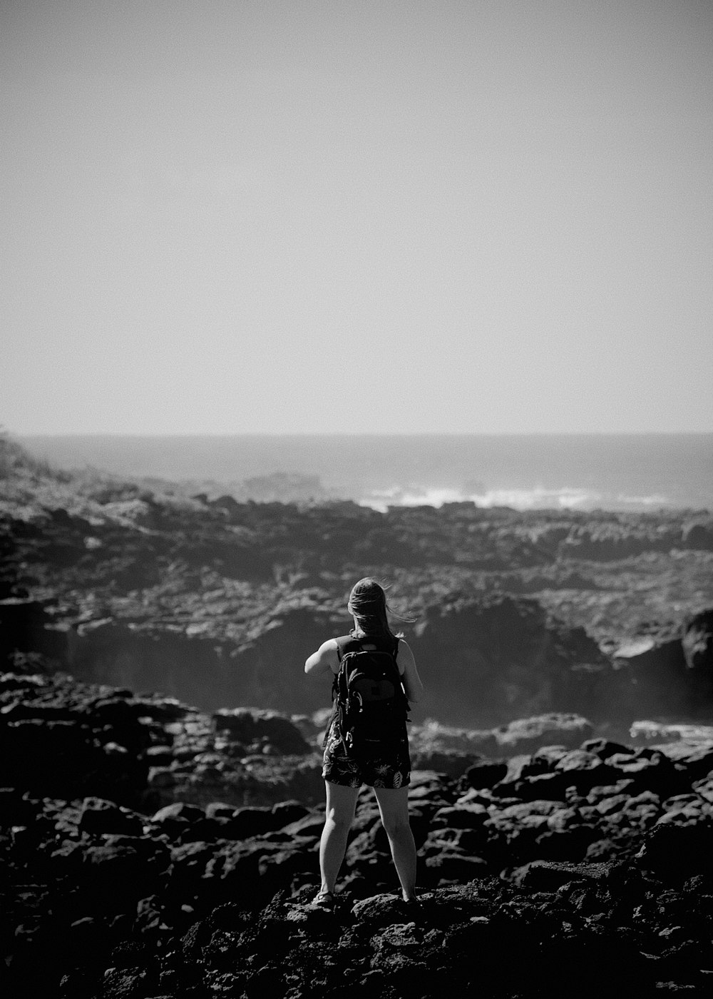 a person standing on a rocky hill