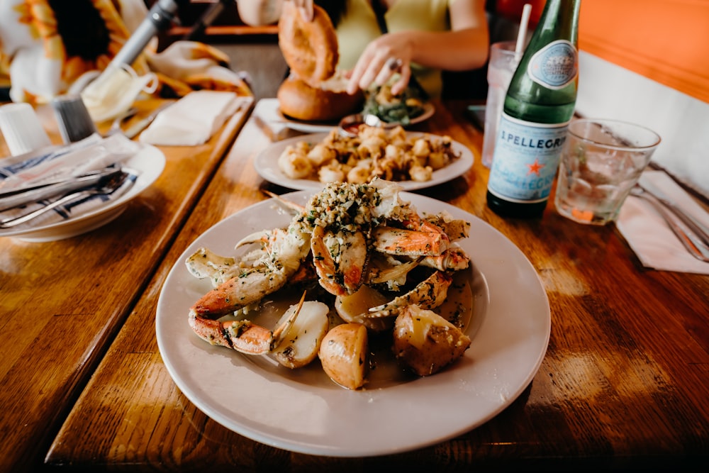 a table with plates of food and bottles of water