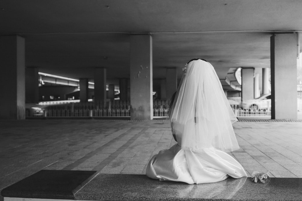 a person in a white dress lying on the floor