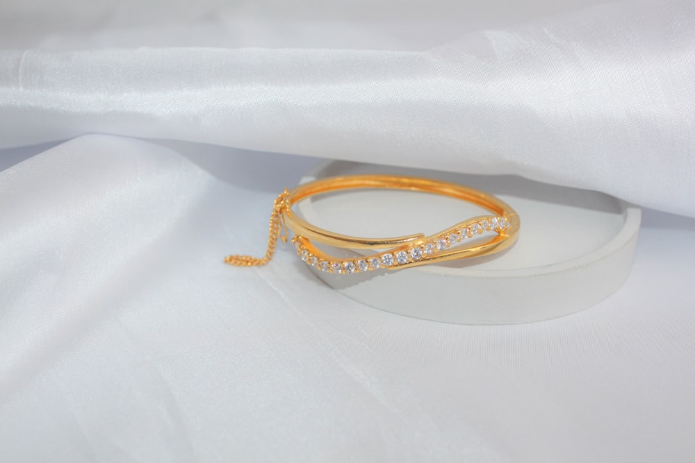 a gold ring on a white surface