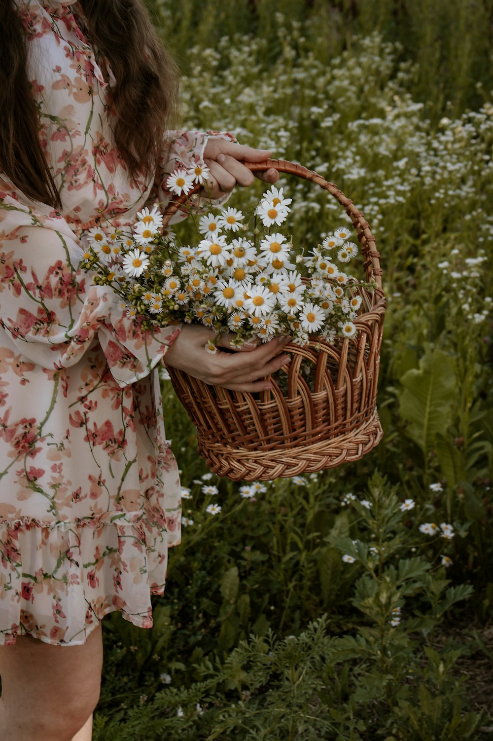 a woman holding a basket of flowers