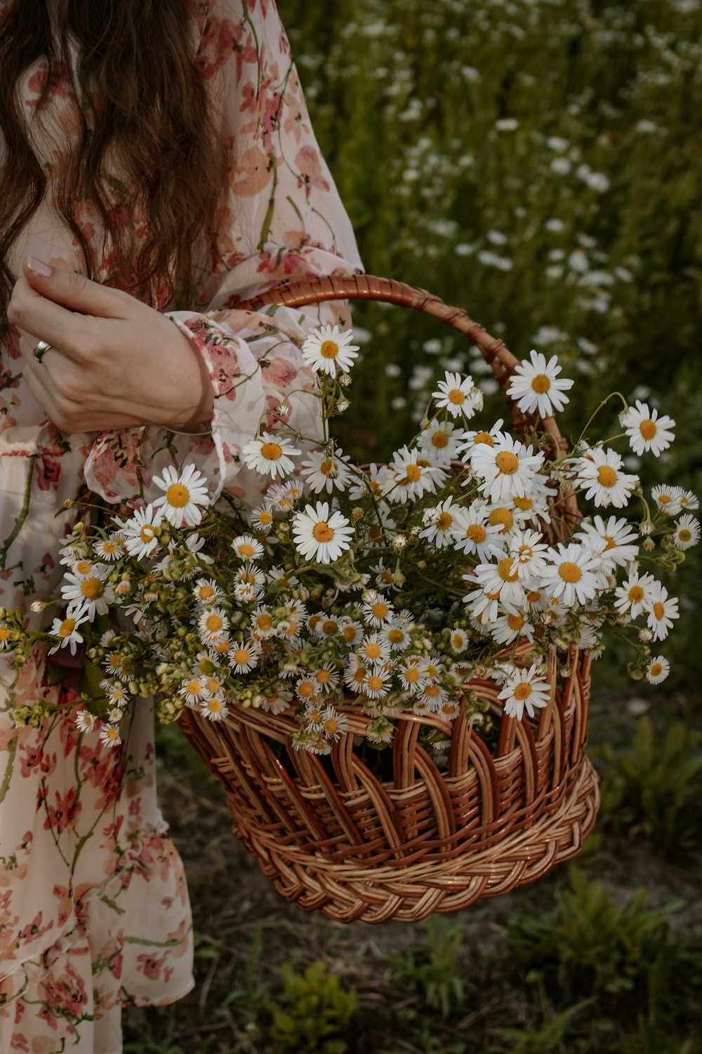 a woman holding a basket of flowers