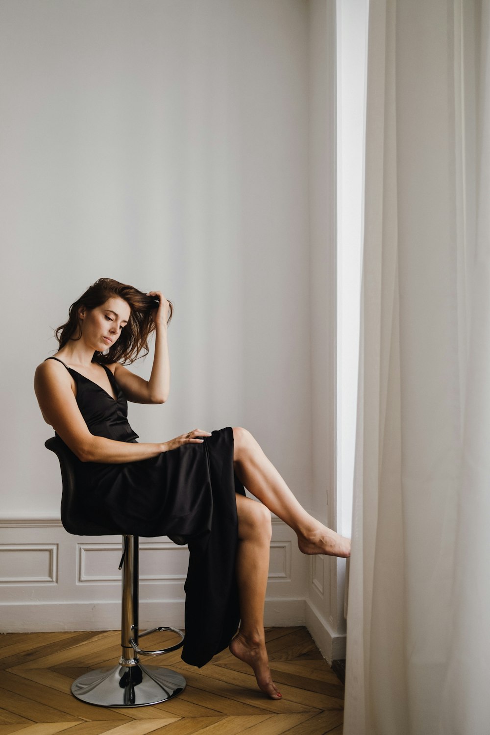 a woman sitting on a stool