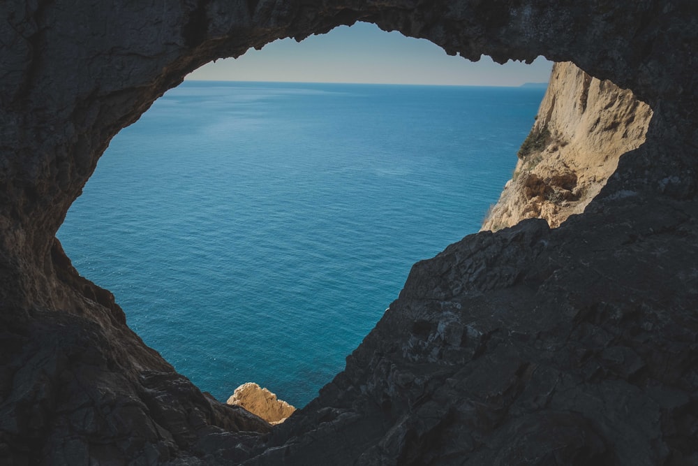 a view of the ocean from a cave