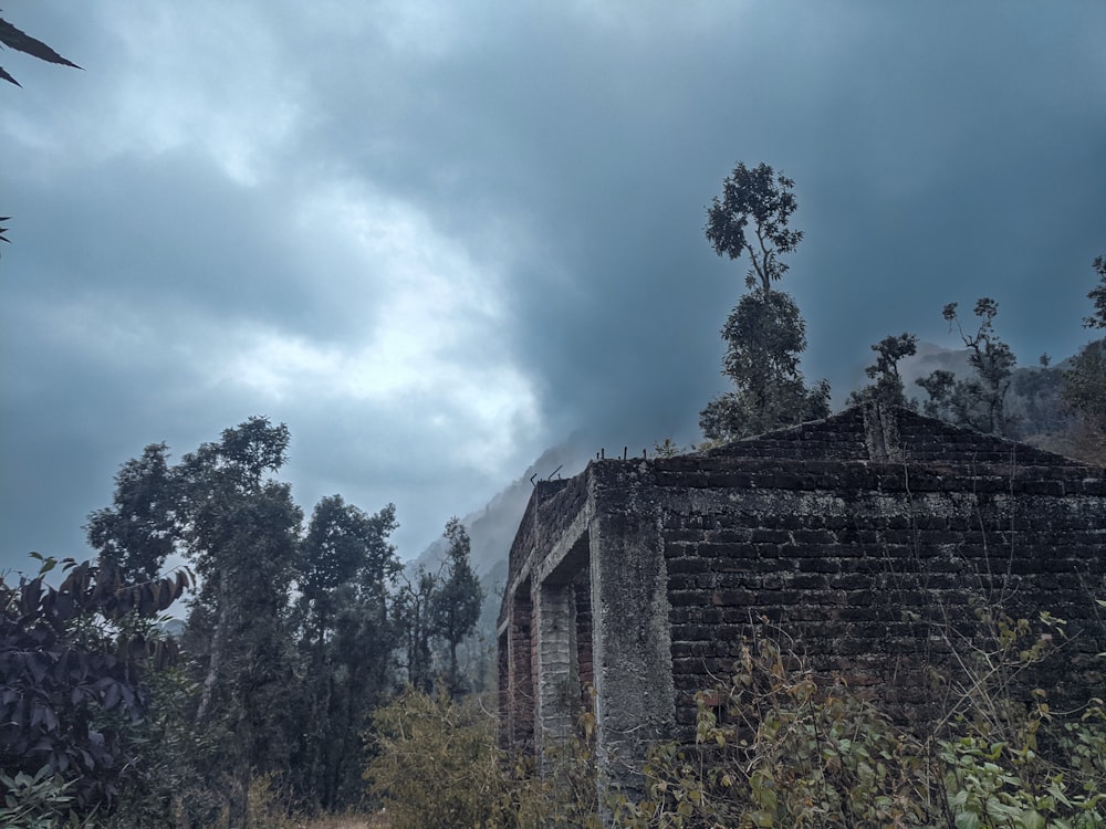 a stone building with trees around it