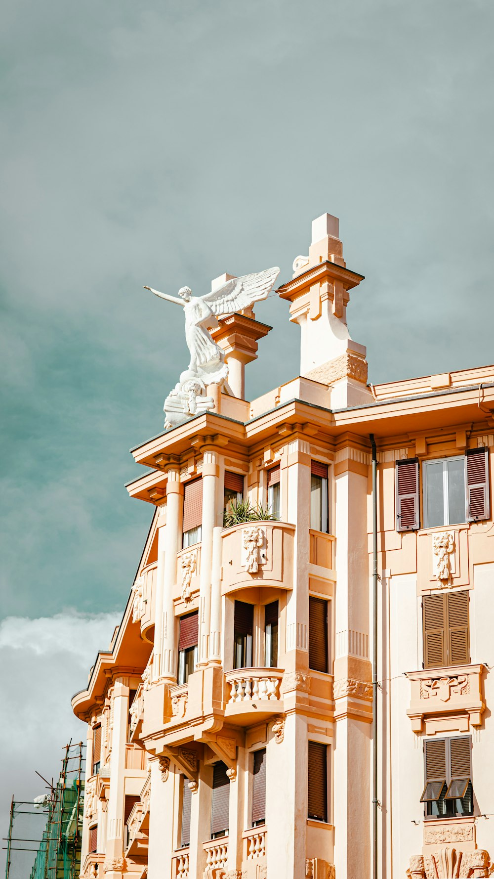 a statue of a person holding a cross on a building