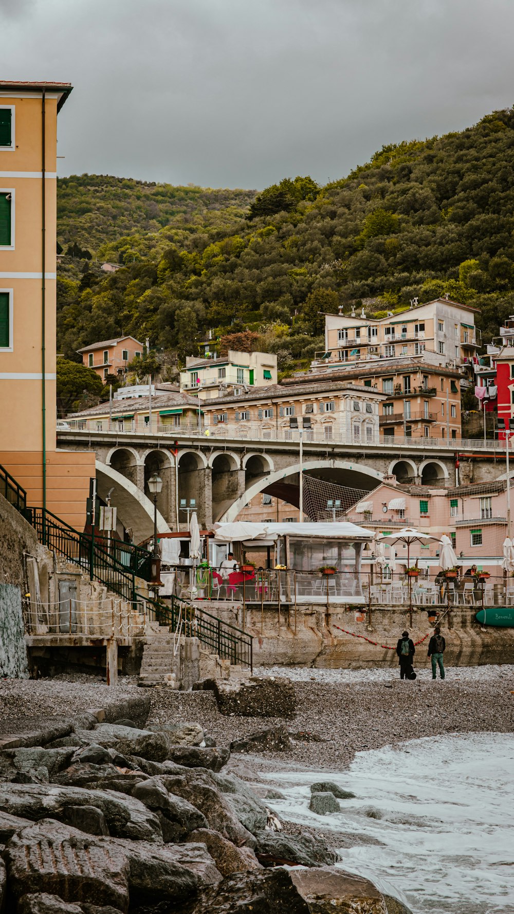 a bridge over a river with people walking on it